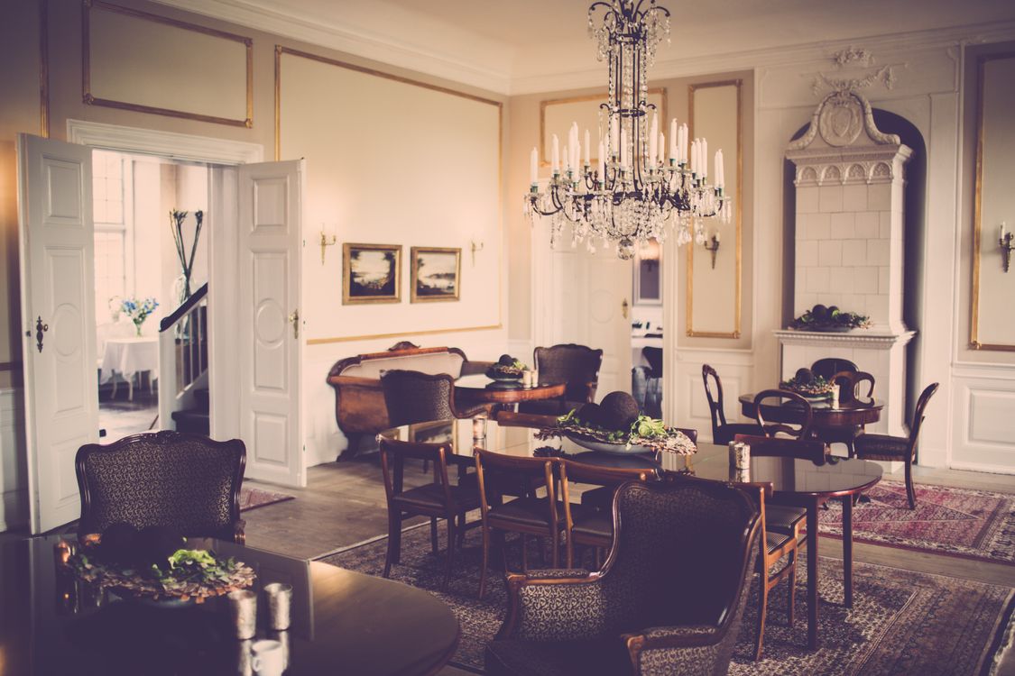 A vintage-style dining room showcasing a grand chandelier and classic furniture
