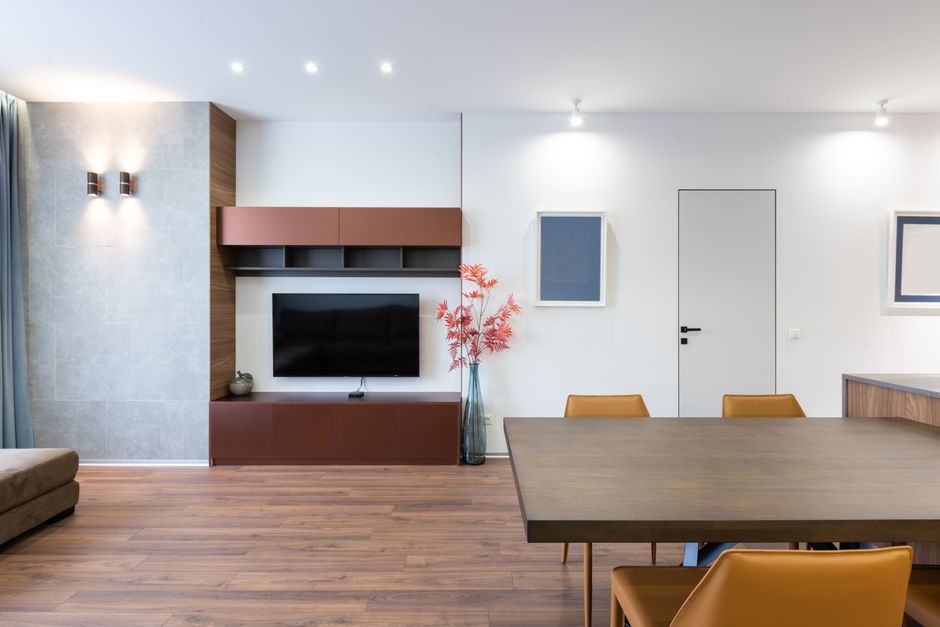 Sala de estar pequena com televisão e mesa lateral