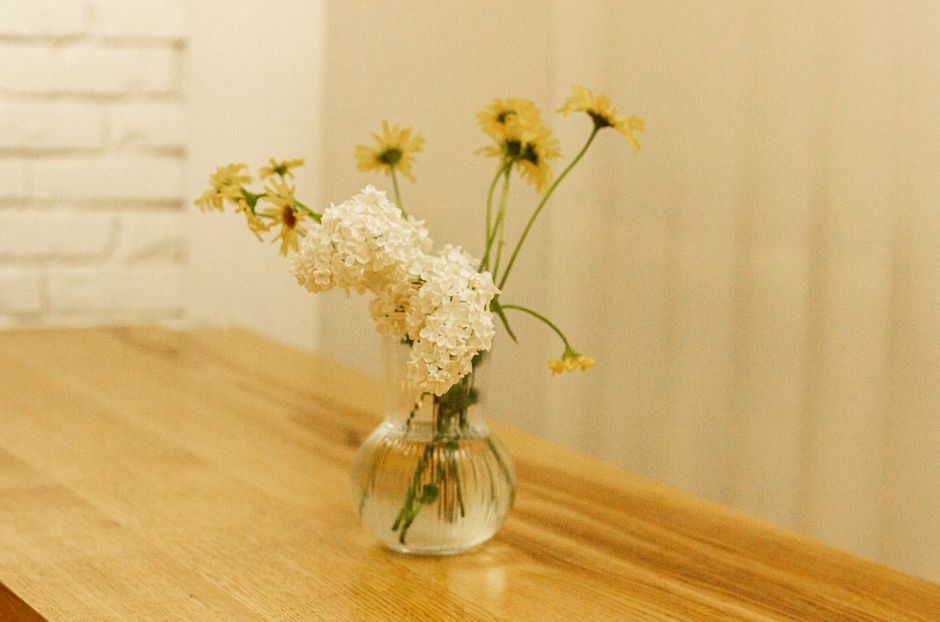 Detalhe em close de vaso de vidro com água e flor